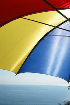 colorful parasol at the ocean on a sunny day