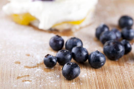 Fresh raw blueberries on cutting board.