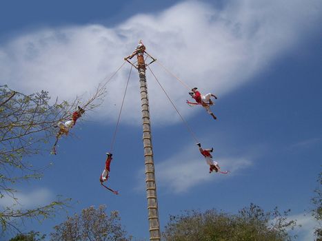 Mexian performers swinging in air upside down, performance.