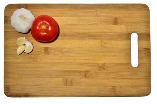 garlic and tomato on a cutting board, isolated on white