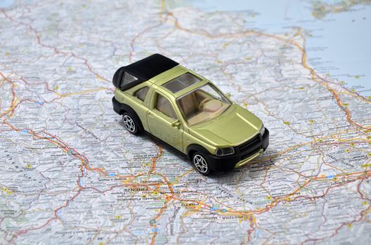 concept small green pickup toy car on italy map