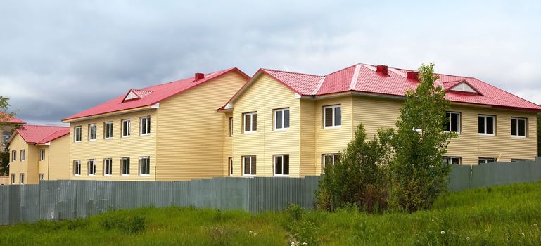 Construction of the house. Finishing work. Facade. Summer.