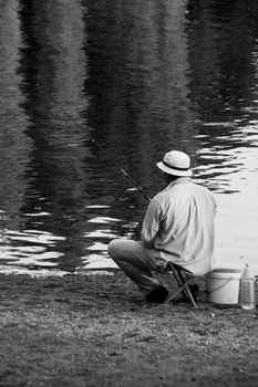 Old men photographed while he is fishing.