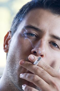 Young attractive men smoking cigarette.