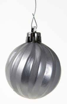 A single isolated silver Christmas bauble hanging. (focus on middle of bauble)
