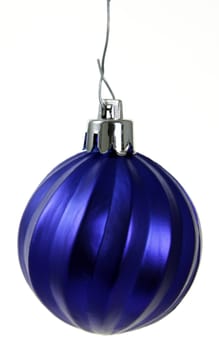 A single isolated blue Christmas bauble hanging.
