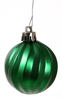 A single isolated green Christmas bauble hanging.
