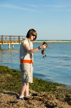 Teen disgusted at the smell of a polluted beach