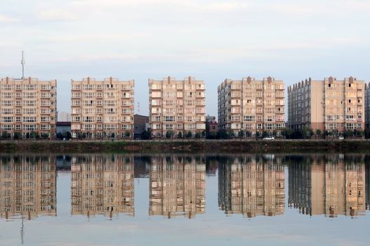 Apartment blocks with mirror by a lake