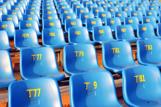 Row of plastic chairs in an open theater
