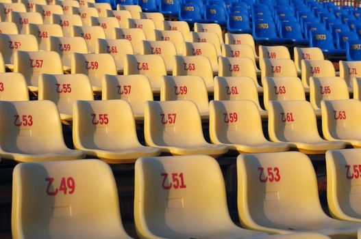 Row of plastic chairs in an open theater