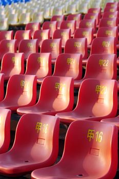 Row of plastic chairs in an open theater