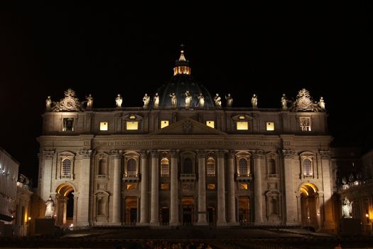 The front of St. Peter's Basilica, in Vatican city at night.
