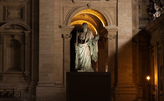 A statue of St. Paul outside St. Peter's Basilica, Vatican City, Rome.  Shot at night.

