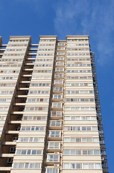 Bottom view of modern apartment buildings against blue sky