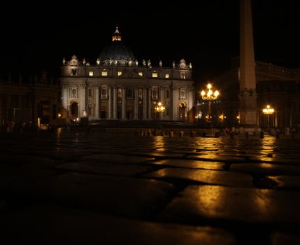 St. Peter's Basilica, in Vatican city at night, shot from the ground of St. Peter's Square.
