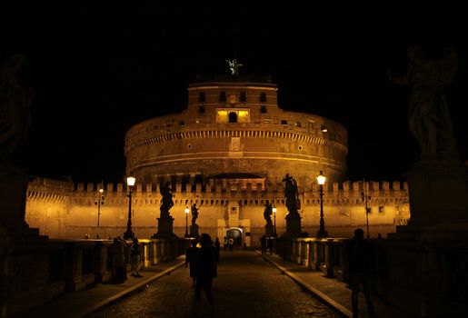 The towering Castel Sant'Angelo (Mausoleum of Hadrian) in Rome, Italy.  Shot at night from Ponte Sant Angelo.

