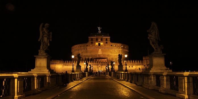 The towering Castel Sant'Angelo (Mausoleum of Hadrian) in Rome, Italy.  Shot at night from Ponte Sant Angelo.
