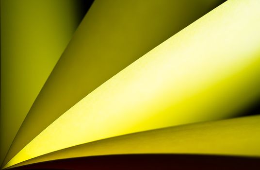 Yellow notepad paper illuminated by LED light with black back in landscape