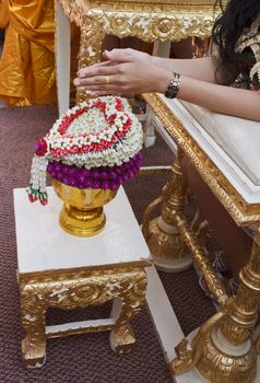 Hand of bride wait for blessed water at Thai wedding ceremony in Thailand