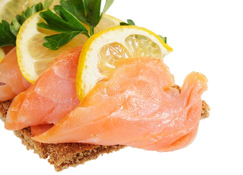 Sandwich snack - salmon with lemon on rye bread. Isolated on white.