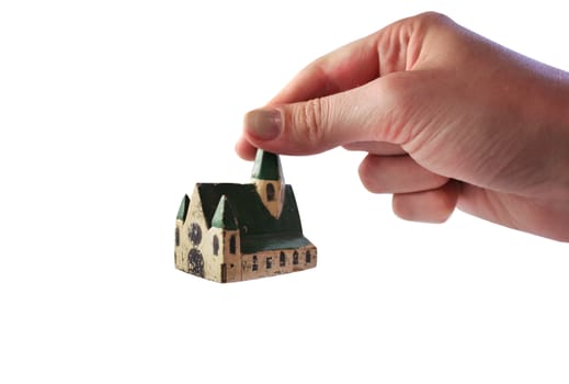 We see the hand with old house on isolated white.
