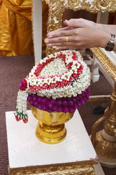 Hand of bride wait for blessed water at Thai wedding ceremony in Thailand