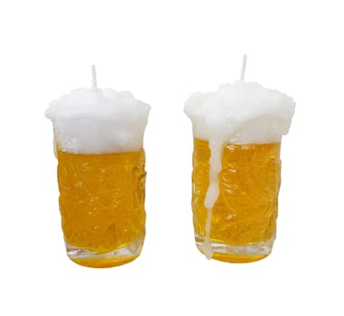 Glass of light beer candle made from paraffin wax isolated on white background