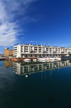 warehouse, fishing boat and sail boat in Genoa port, Italy