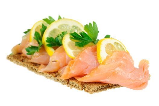 Sandwich snack - salmon with lemon on rye bread. Isolated on white.