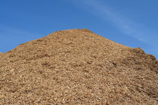 Pile of wood chips mulch for gardening and heating background