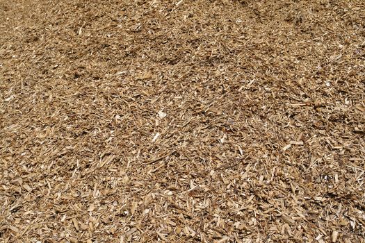 Pile of wood chips mulch for gardening and heating background