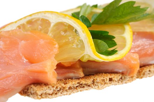 Sandwich snack - salmon with lemon on rye bread. Isolated on white.