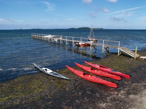 Colorful sea kayaks on the beach ready for extreme sport action wide angle view