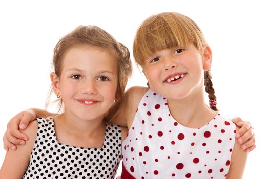 Two happy little sisters portrait isolated on white