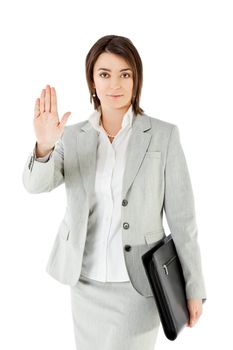 Businesswoman standing on white background, showing stop sign with hand