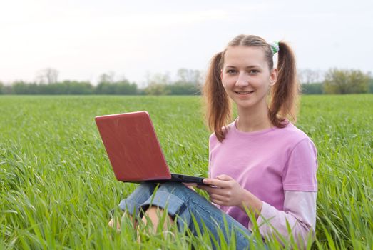 Teen girl with a notebook sitting outdoors