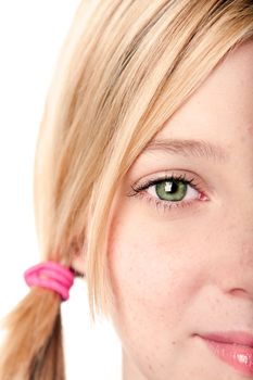 Beautiful green watchful eye of a teenage girl with blond hair pigtail, isolated.