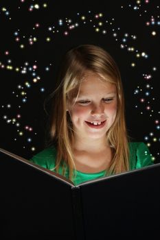 Pretty young school girl engrossed in reading a fantasy story.