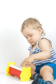 Small baby boy with a toy pyramid isolated on white