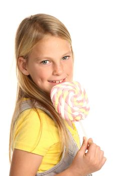 Pretty young school girl with a marshmallow candy stick