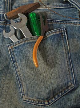 Blue jean pocket with spanners and screwdriver