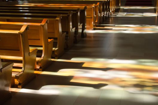 reflection of the stained glass windows inside a church