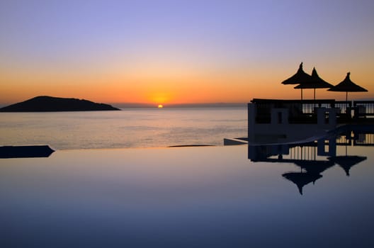 the pool and the sea at sunset
