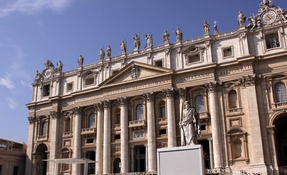 The front of St. Peter's Basilica, in Vatican city.  Featuring the imposing statue of Saint Paul.
