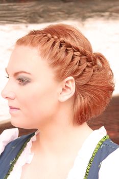 Red-haired woman with traditional hairstyle Bavarian