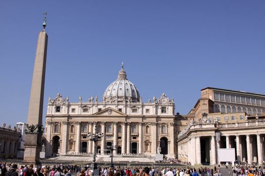 Saint Peter's Square featuring an ancient Eygptian obelisk and St. Peter's basilica in the background.  Shot in the Vatican City.
