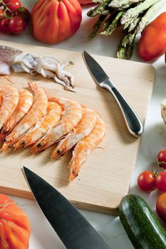 still life of raw seafood and vegetables