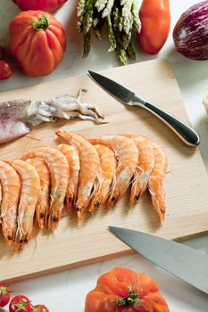 still life of raw seafood and vegetables