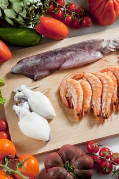 still life of raw seafood and vegetables